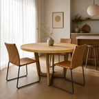 Ashburton Dining Table: warm oak round table with soft curves and clean architectural base in a calm NZ dining space.