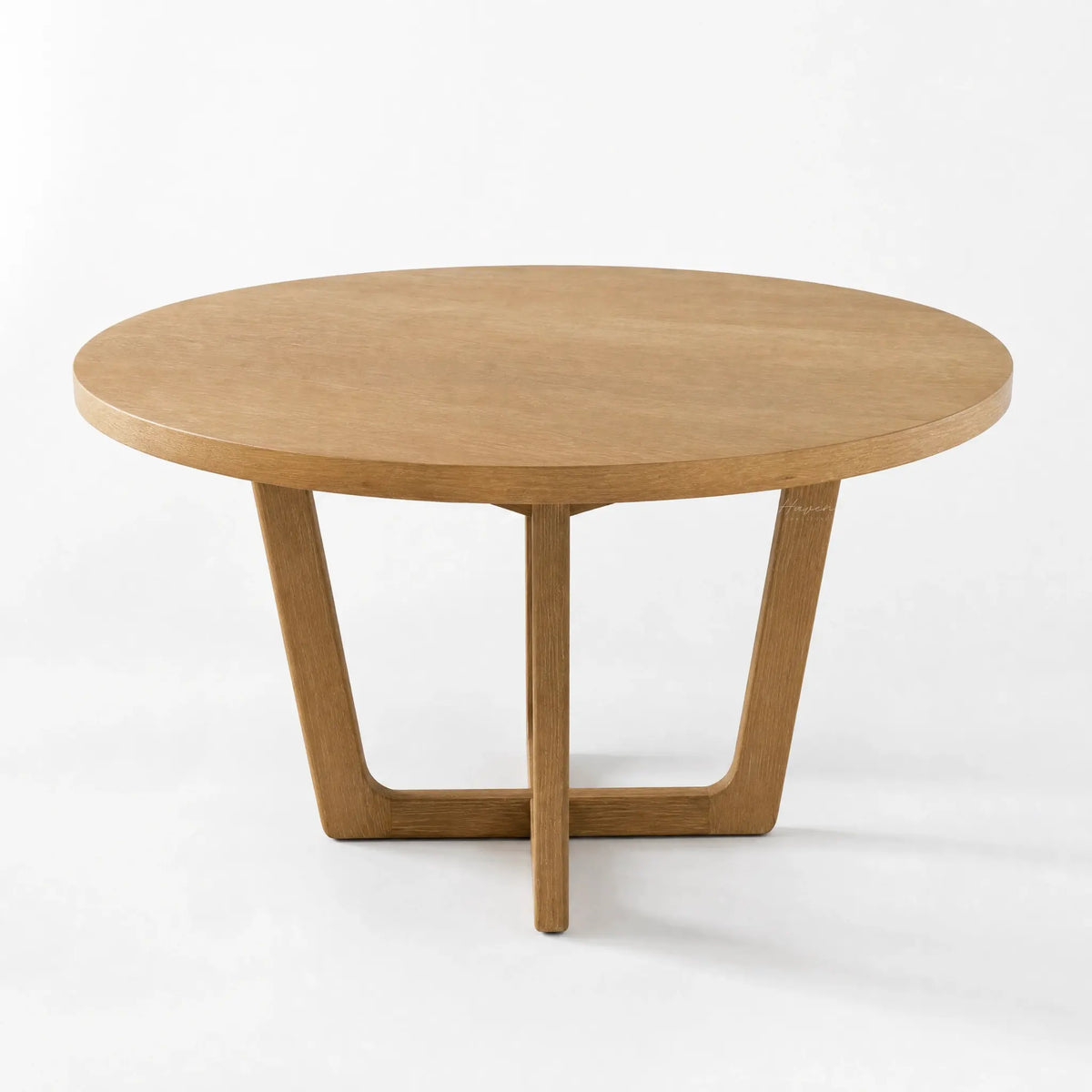 Ashburton Dining Table: round oak top with soft curves and a clean architectural base.