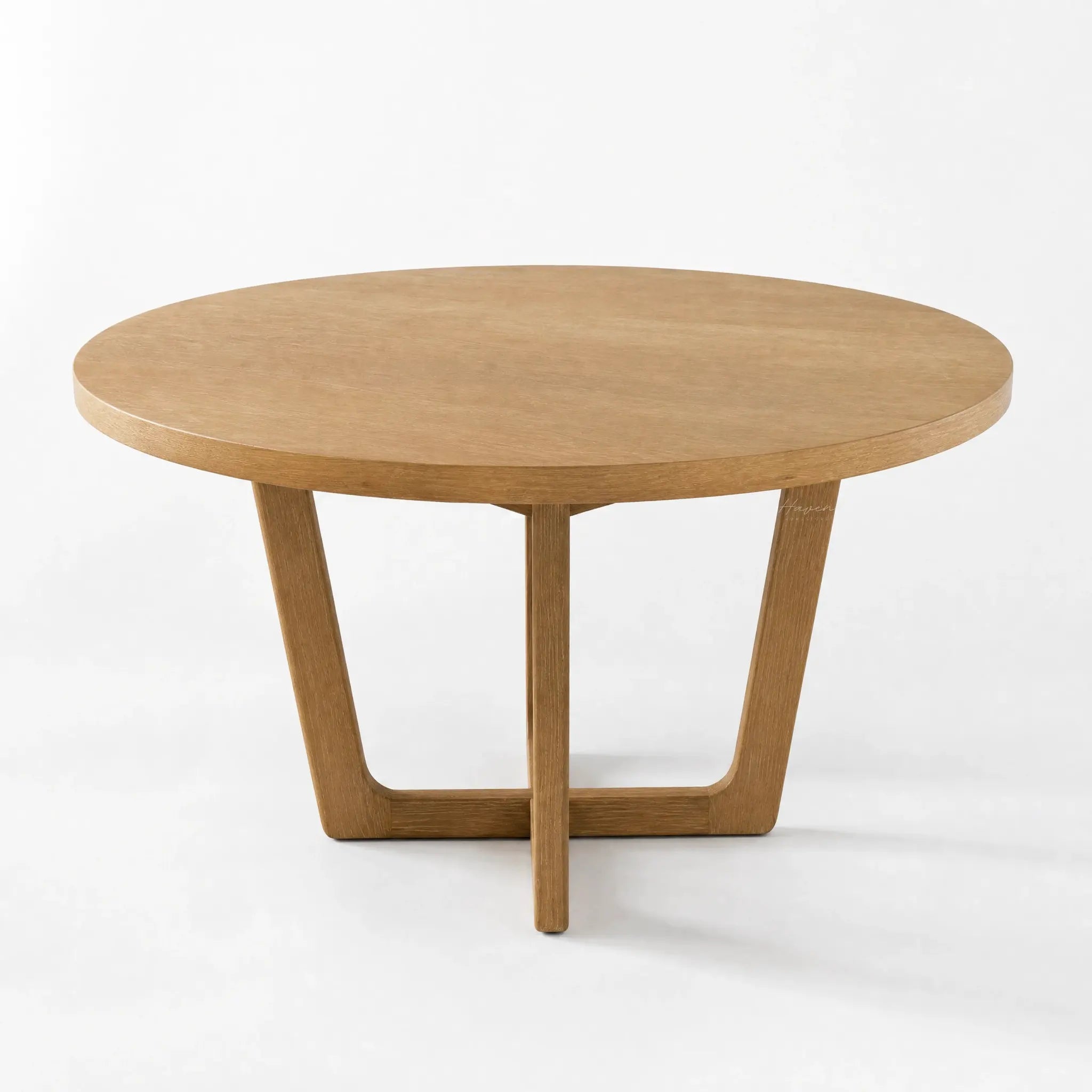 Ashburton Dining Table: round oak top with soft curves and a clean architectural base.