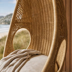 Rattan Pod Chair with airy cocoon shape, handwoven natural rattan for calm, playful relaxation.