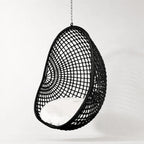 Check Pod Chair: black woven hanging chair with white cushion, polyethylene fibres, galvanised frame.