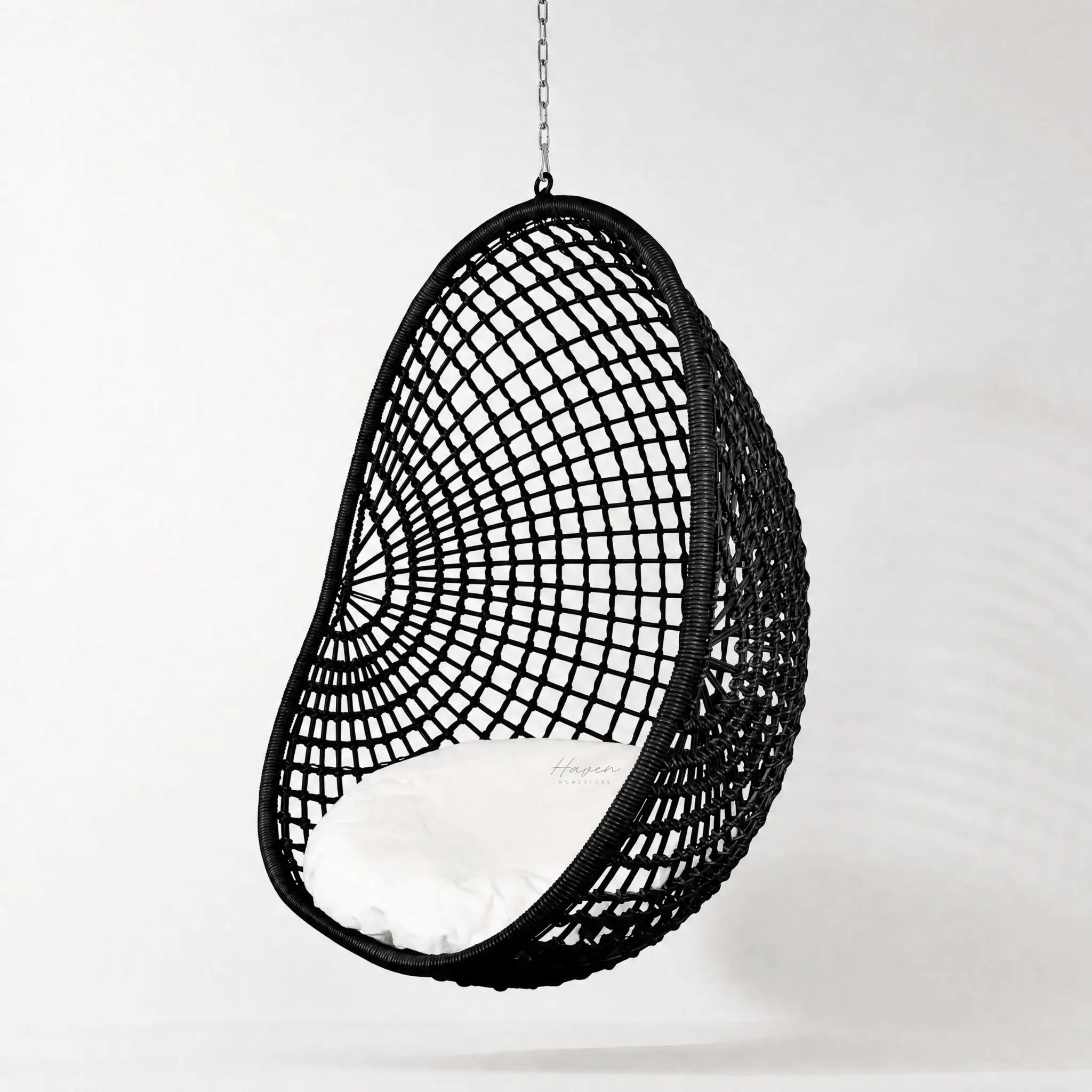 Check Pod Chair: black woven hanging chair with white cushion, polyethylene fibres, galvanised frame.