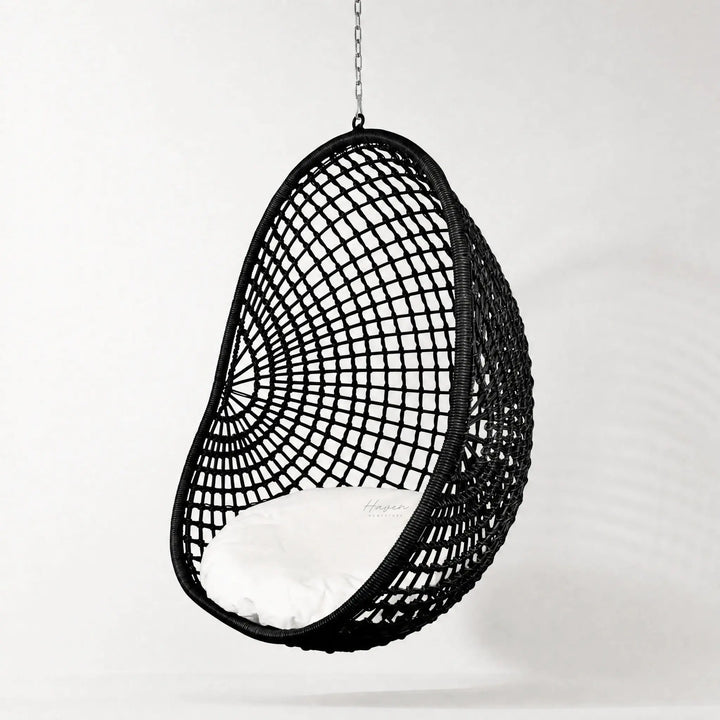 Check Pod Chair: black woven hanging chair with white cushion, polyethylene fibres, galvanised frame.