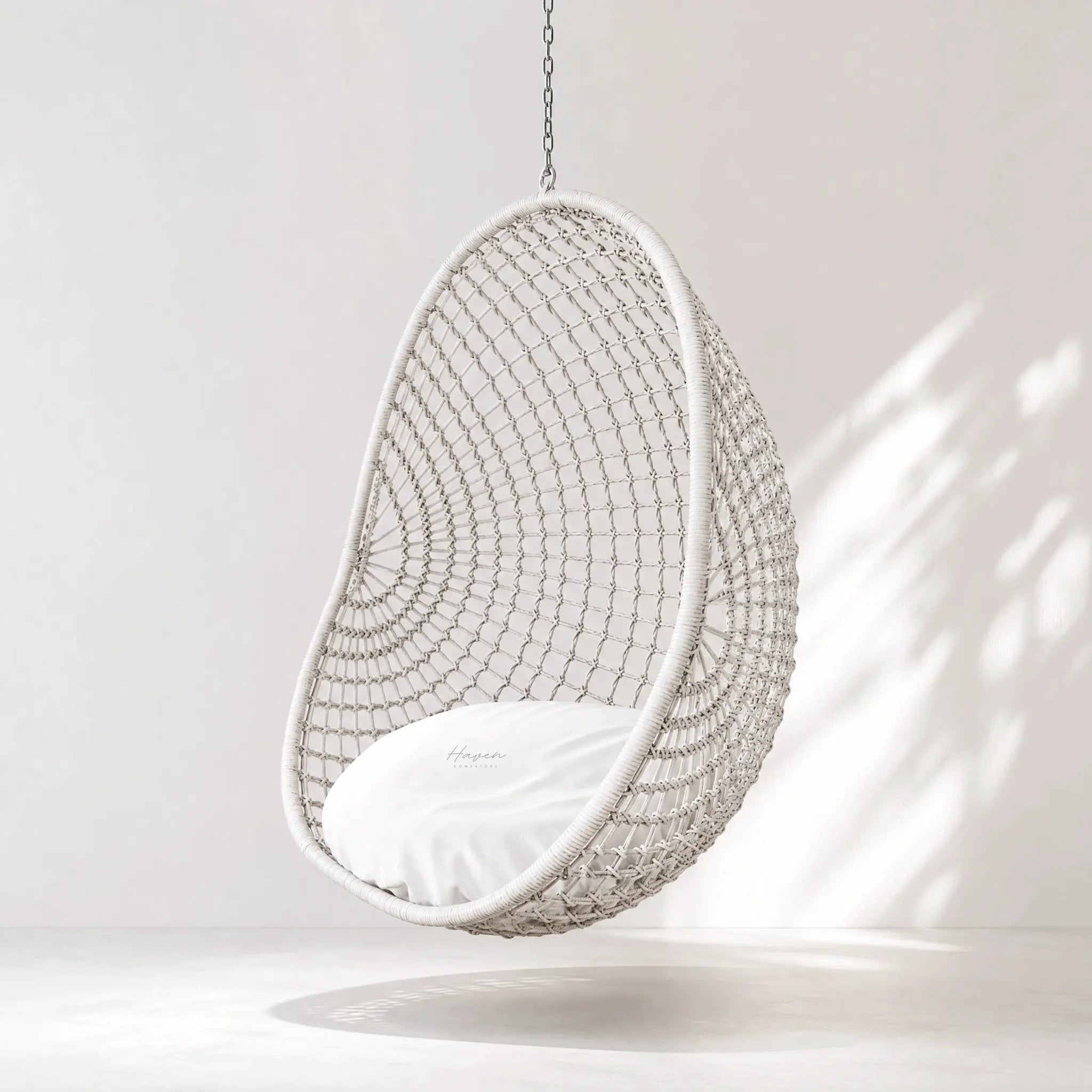 Check Pod Chair hanging wicker pod chair with chain suspension in white.