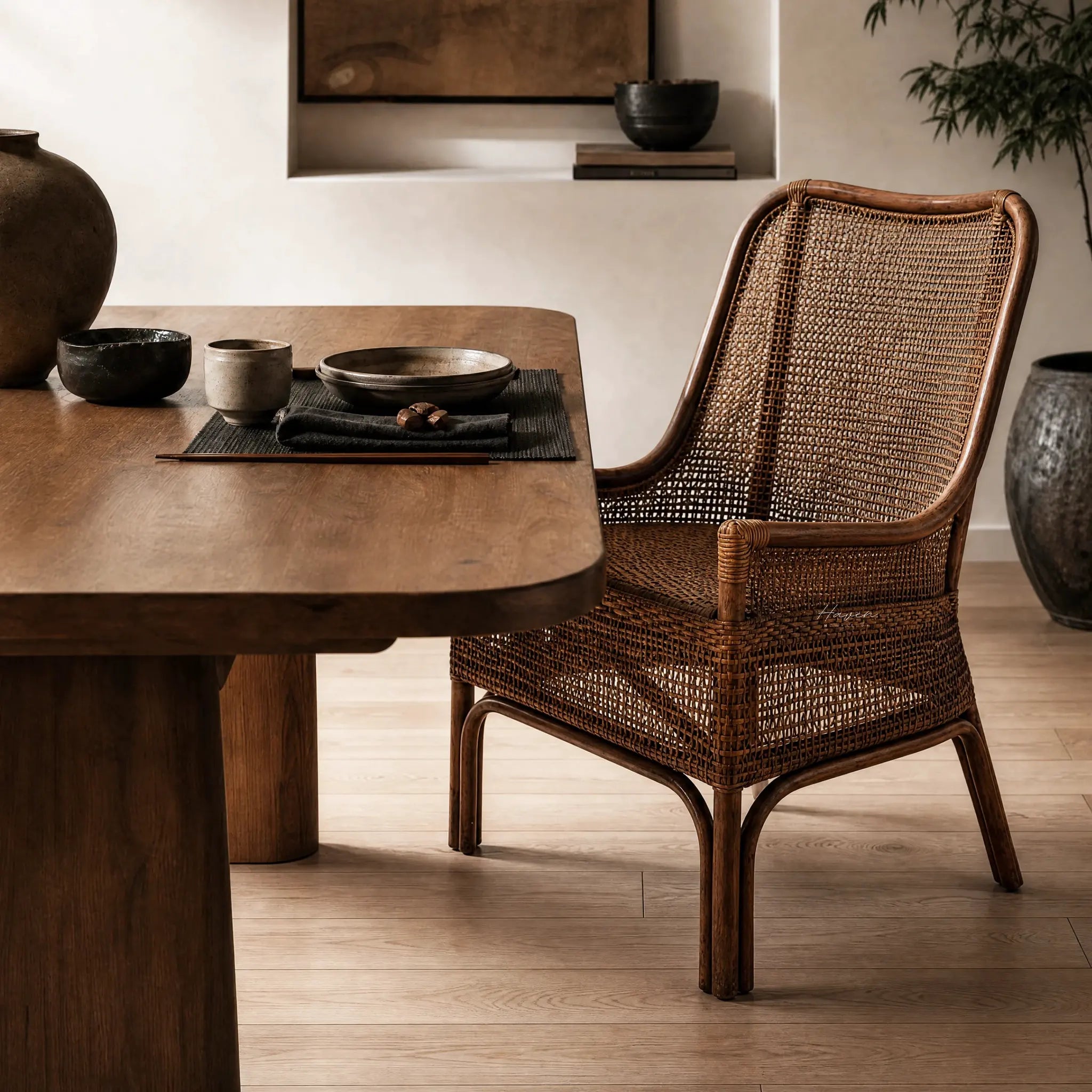 Albany Chair handwoven in natural rattan with a curved silhouette, adding warm texture to a dining space.