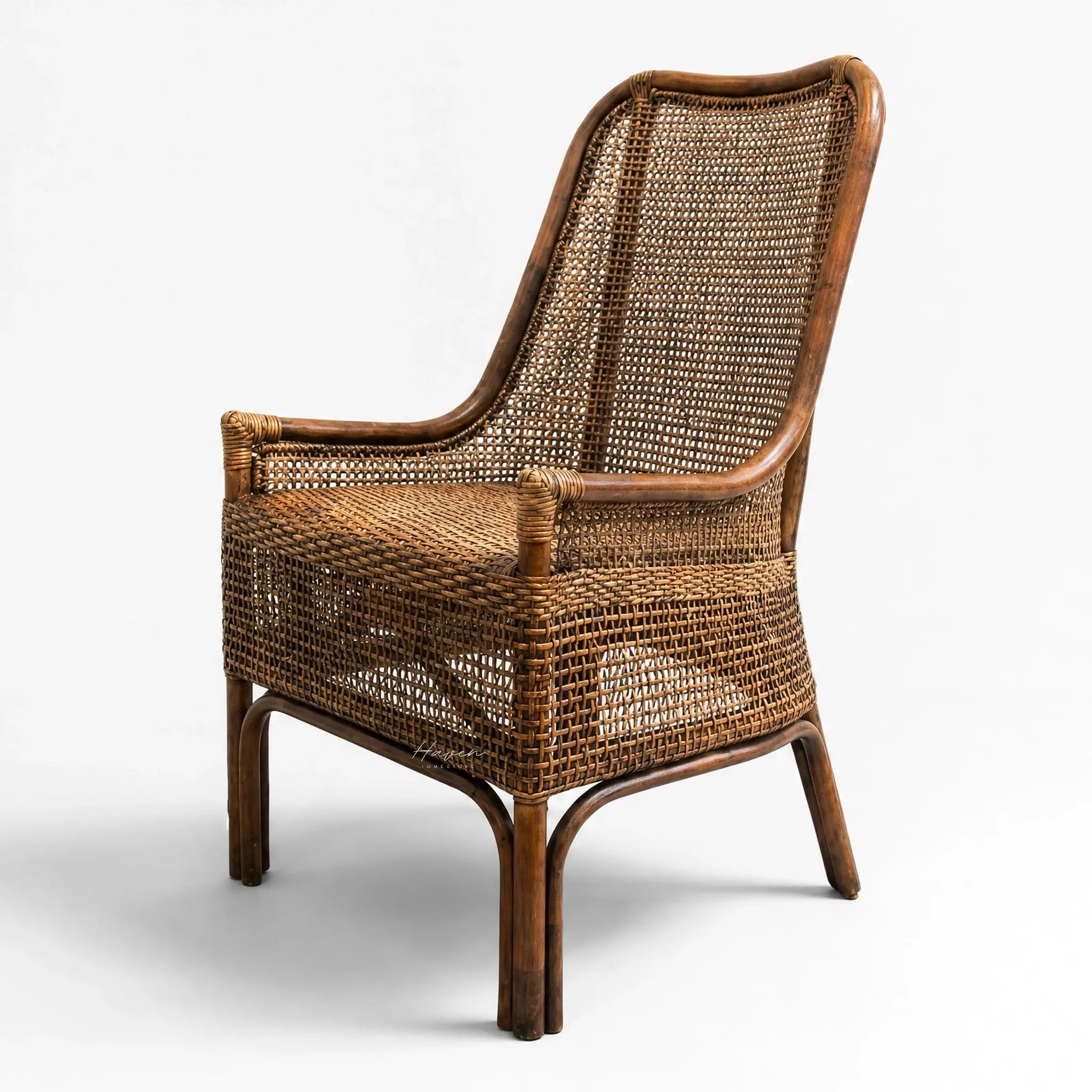 Albany Chair handwoven in natural rattan with a curved silhouette and warm, textured seating.