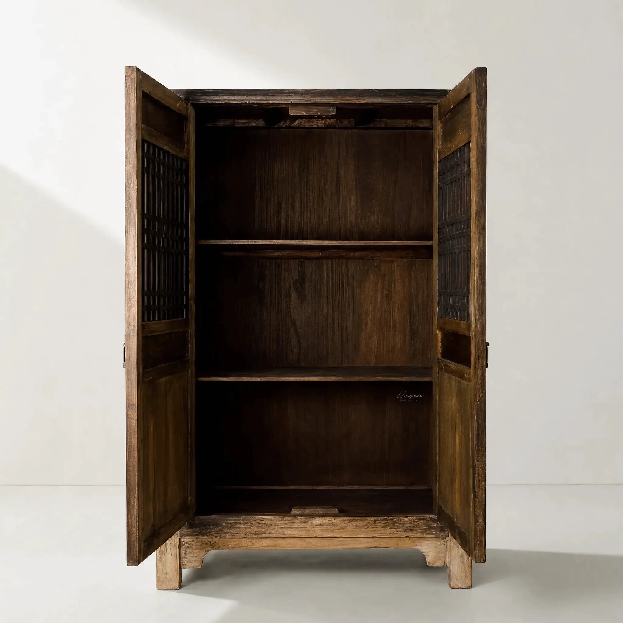 Nomad 2 Door Cabinet in weathered reclaimed pine with carved detailing and paneled doors.