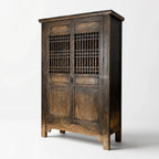 Nomad 2-Door Cabinet in weathered reclaimed pine with carved panels and lattice doors.