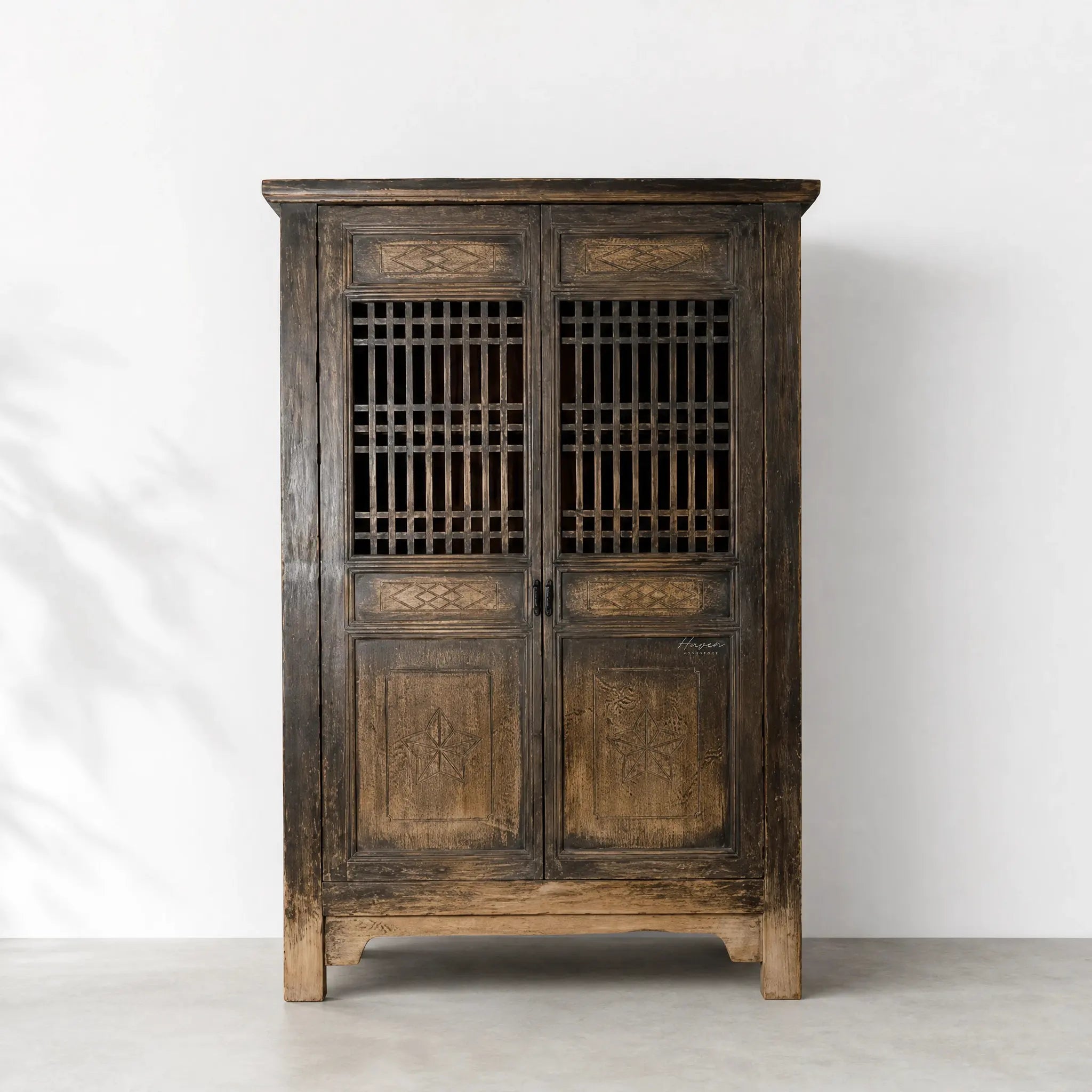 Nomad 2 Door Cabinet in weathered reclaimed pine, carved panels and lattice-front doors.