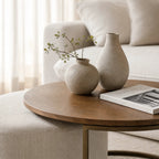 Eleanor Coffee Table + Ottoman with ashwood top and iron frame, neutral living room setup with beige vases.