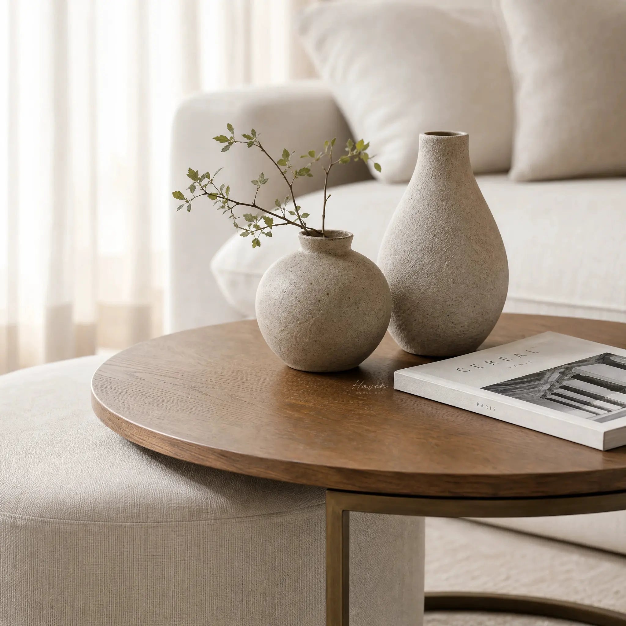Eleanor Coffee Table + Ottoman with ashwood top and iron frame, neutral living room setup with beige vases.