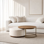 Eleanor Coffee Table + Ottoman with ashwood top and iron frame in a neutral living room.