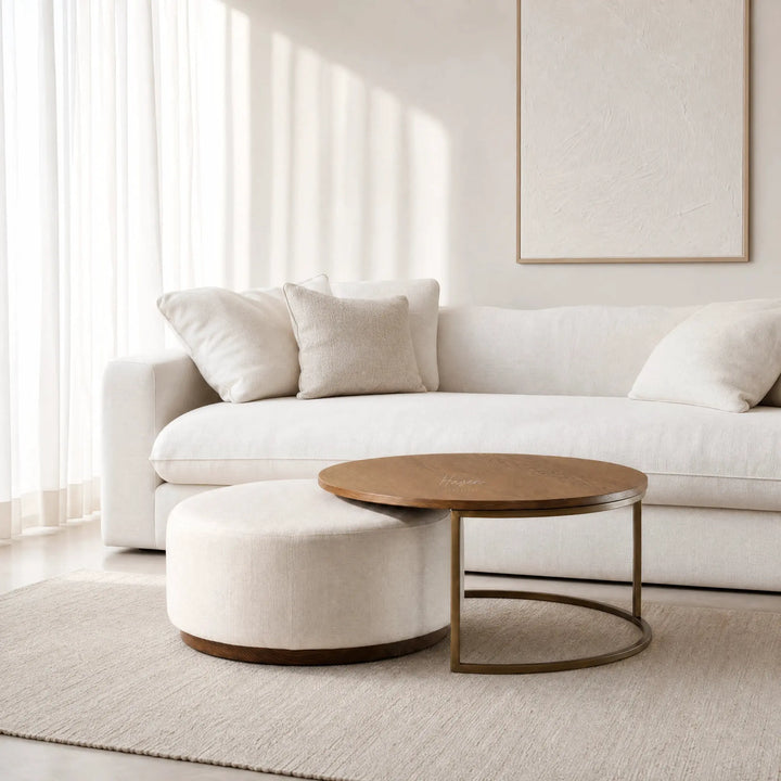 Eleanor Coffee Table + Ottoman with ashwood top and iron frame in a neutral living room.