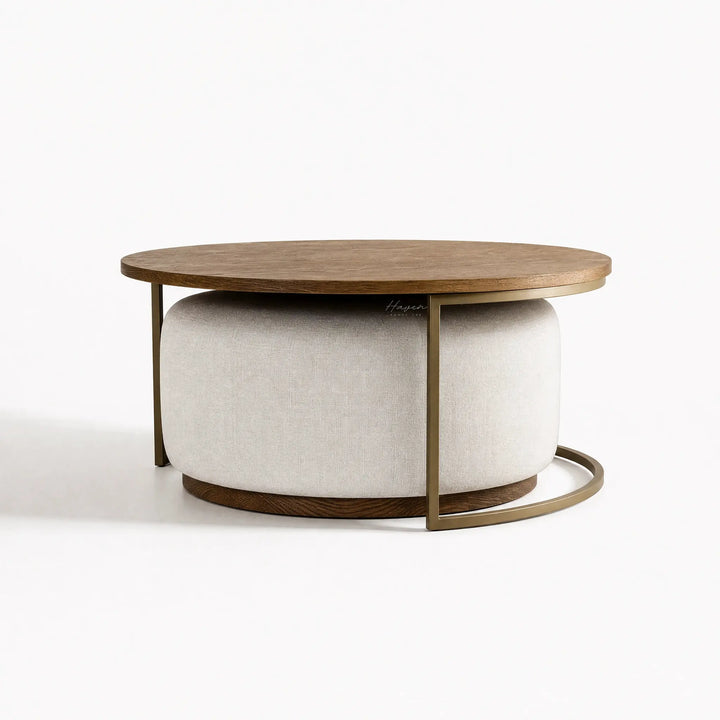 Eleanor Coffee Table + Ottoman: round ashwood top, cushioned gray ottoman, and iron frame.