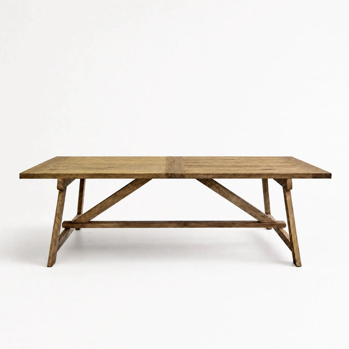 Briar Elm Dining Table in warm reclaimed elm with farmhouse charm and X-frame supports.