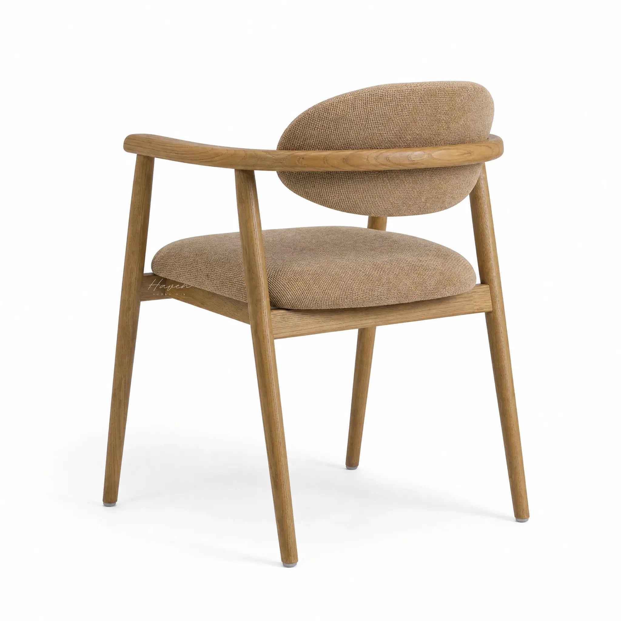 Celine Dining Chair featuring a solid ash frame, curved arms, and tan woven upholstery.