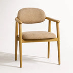 Celine Dining Chair with solid ash frame and beige woven upholstery, curved back.
