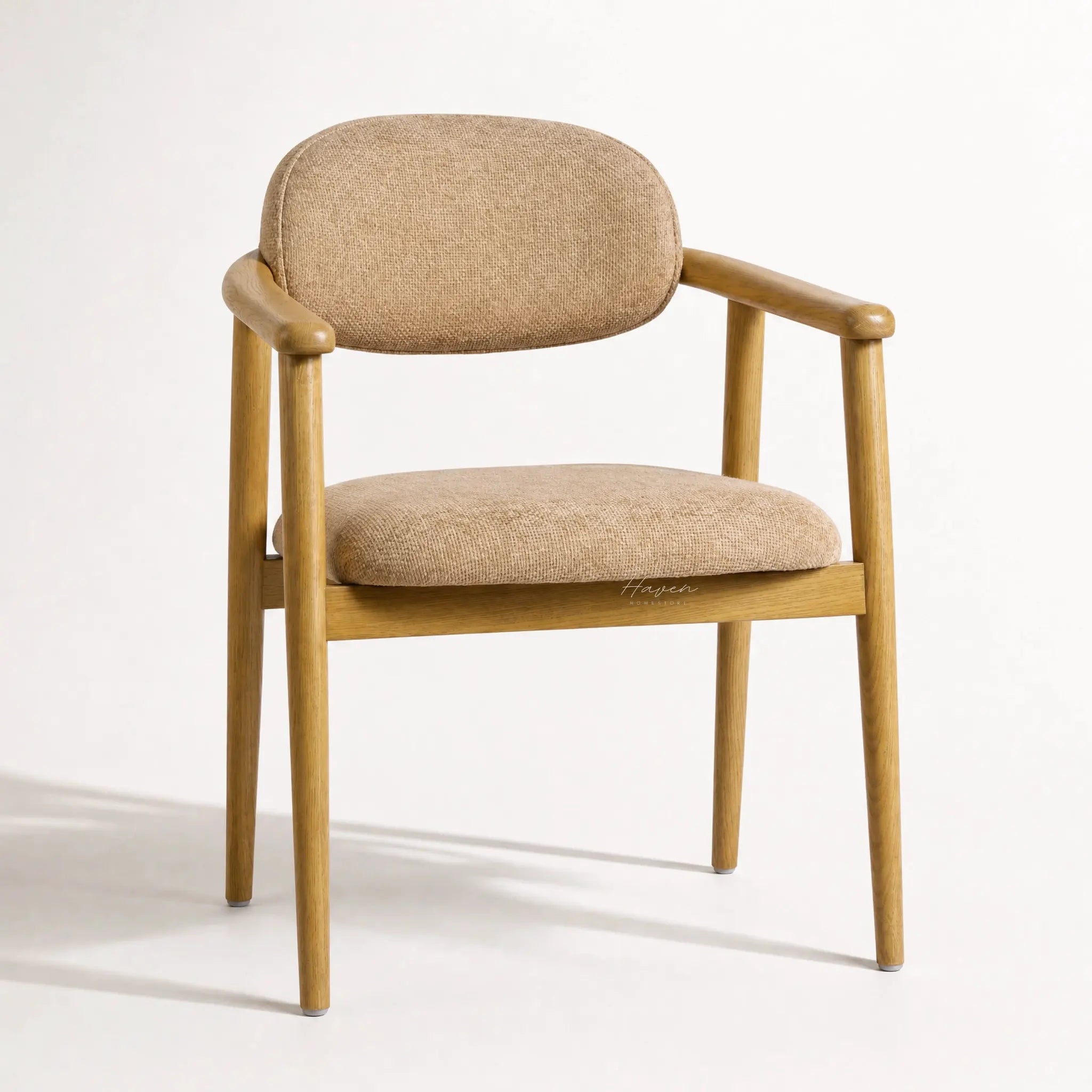 Celine Dining Chair with solid ash frame and beige woven upholstery, curved back.