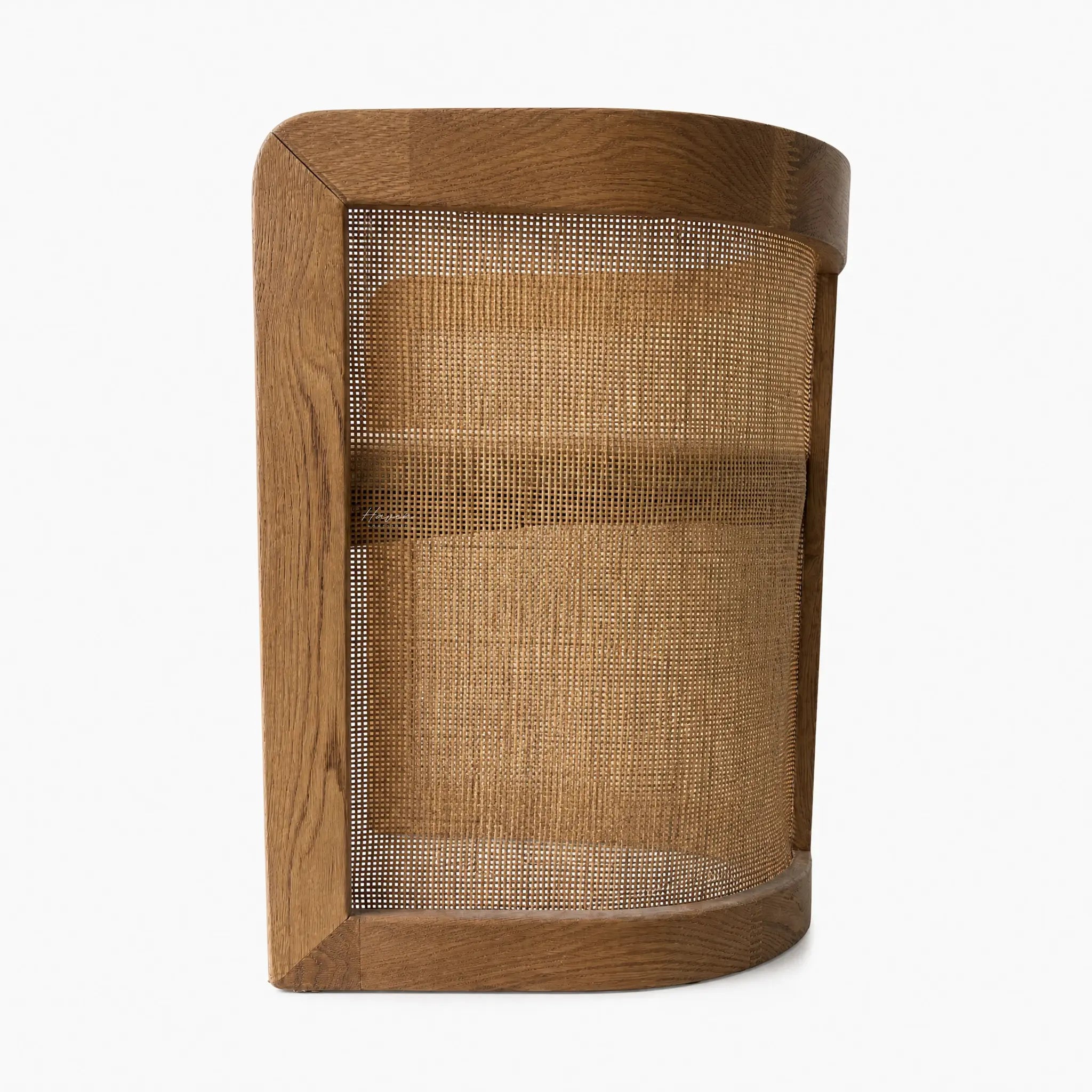 Cove Cane Chair with curved oak frame and woven rattan panels, softly cushioned seat.