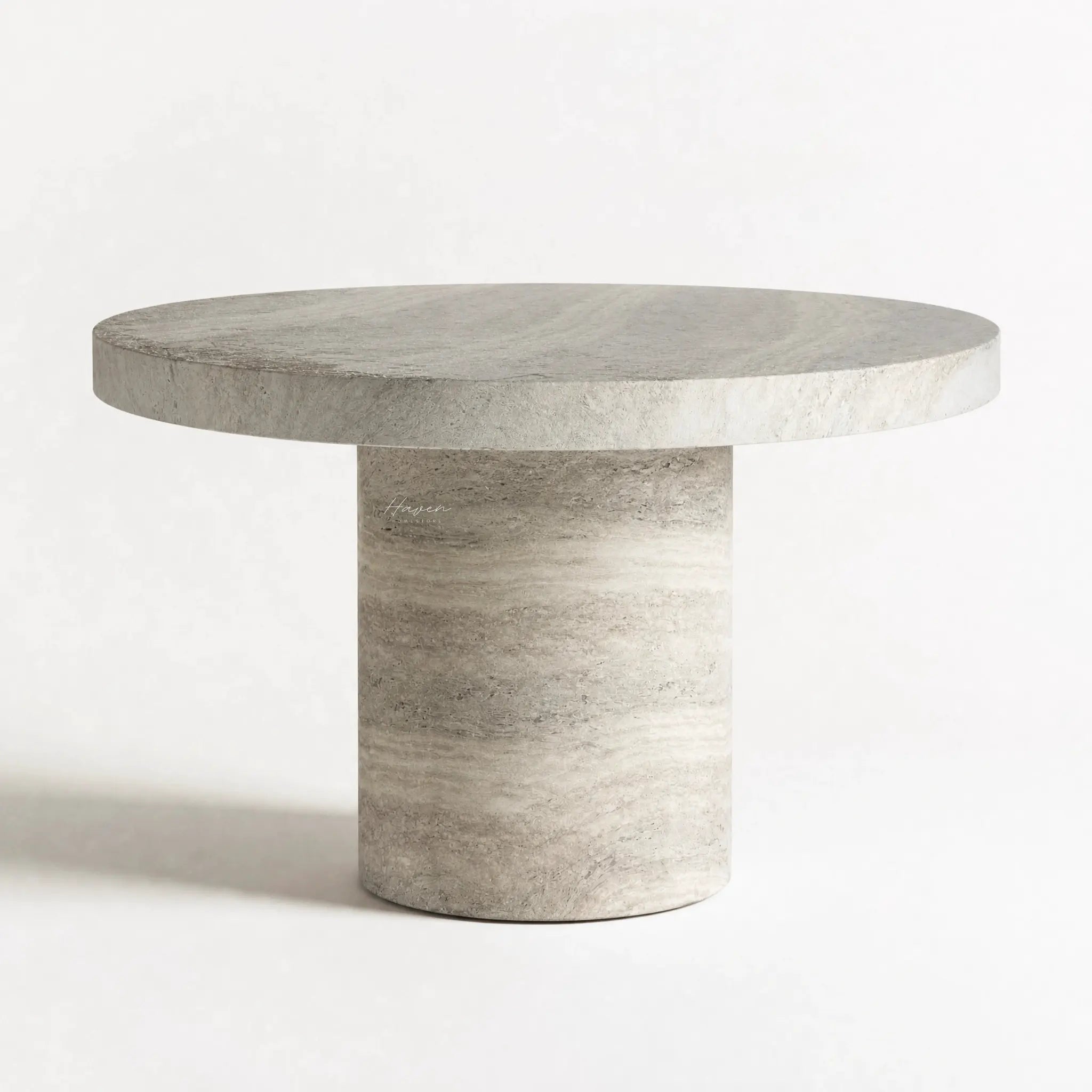 Tivoli Travertine Dining Table with round travertine-look surface and sculptural pedestal base.