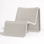 Marina Outdoor Lounge Chair in light gray woven rattan with curved arms, coastal resort vibe.