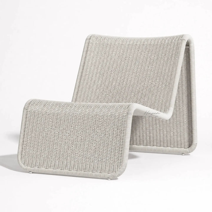 Marina Outdoor Lounge Chair in light gray woven rattan with curved arms, coastal resort vibe.
