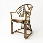 Tulum Dining Chair with curved natural cane frame, open woven back, and soft polyester seat cushion.