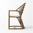 Tulum Dining Chair with curved natural cane frame, open woven back, and soft polyester cushion.
