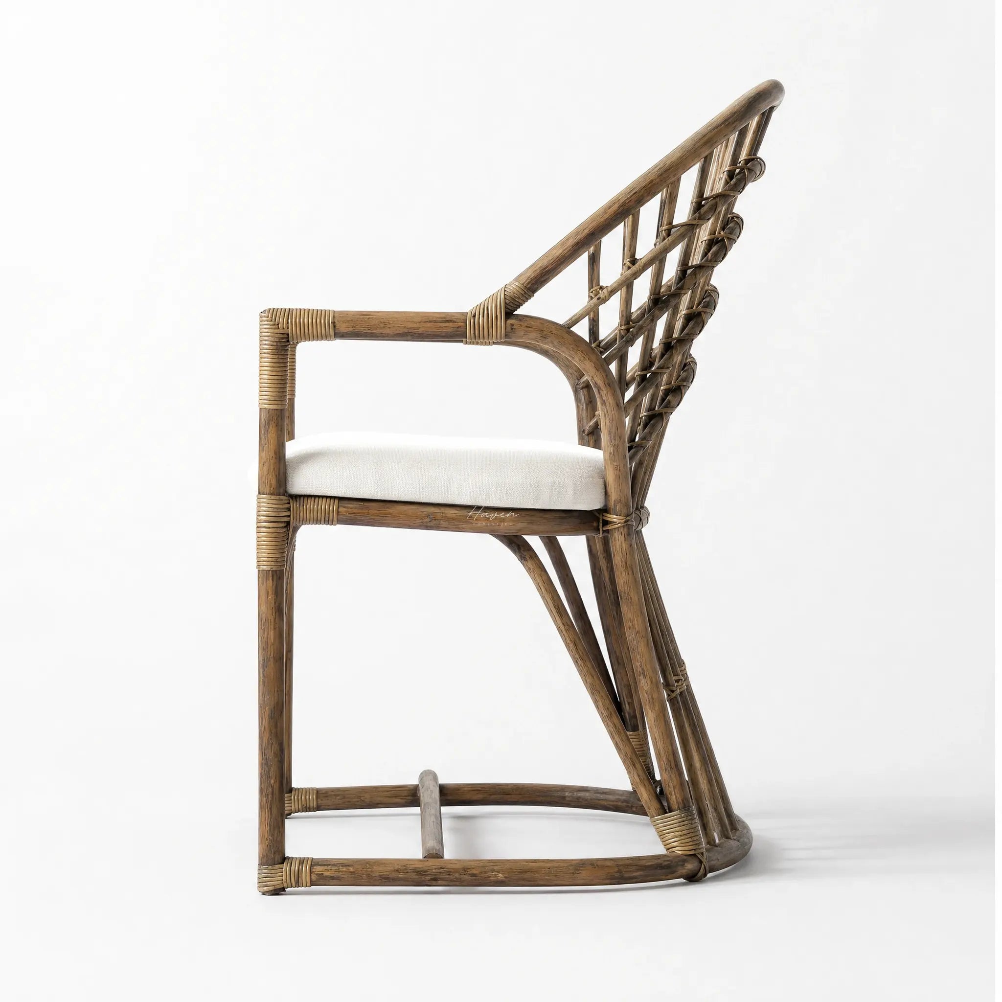 Tulum Dining Chair with curved natural cane frame, open woven back, and soft polyester cushion.