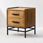 Carlton 2 Drawer Bedside Table in natural oak with black handles and slim metal base.