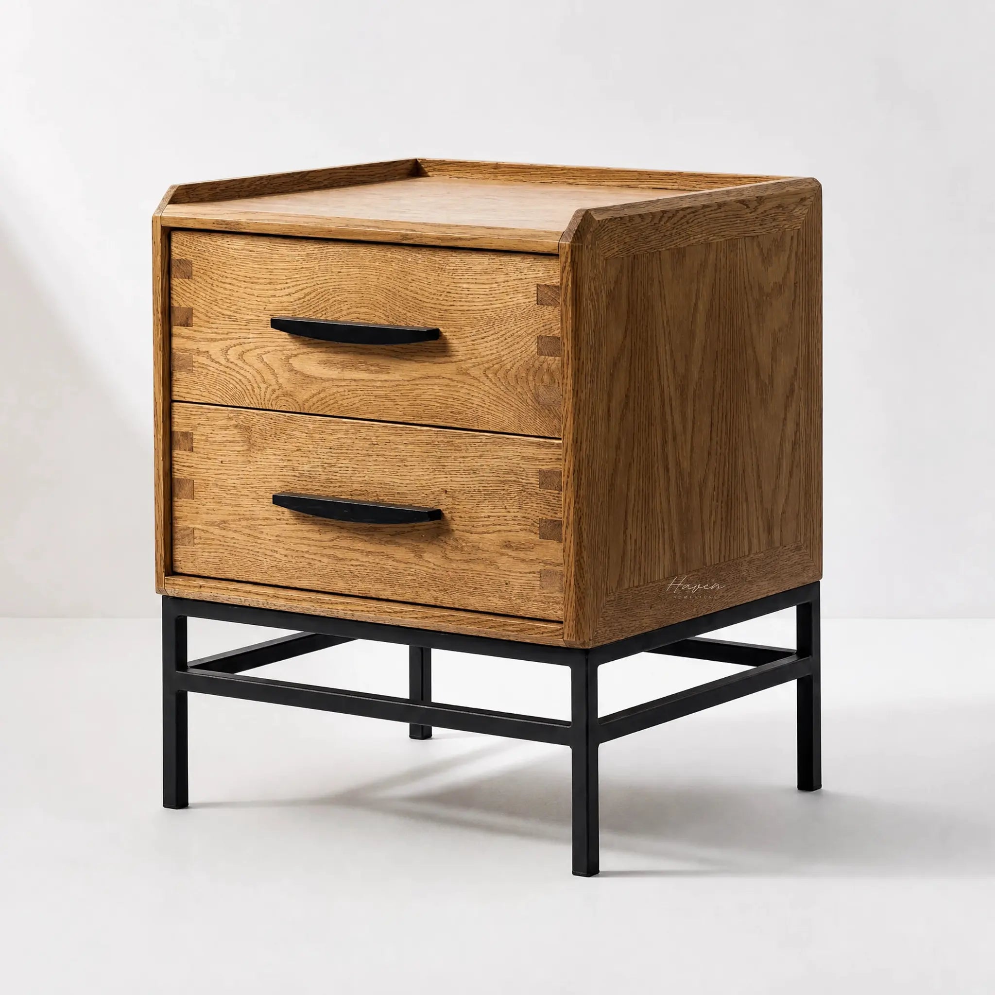 Carlton 2 Drawer Bedside Table in natural oak with black handles and slim metal base.