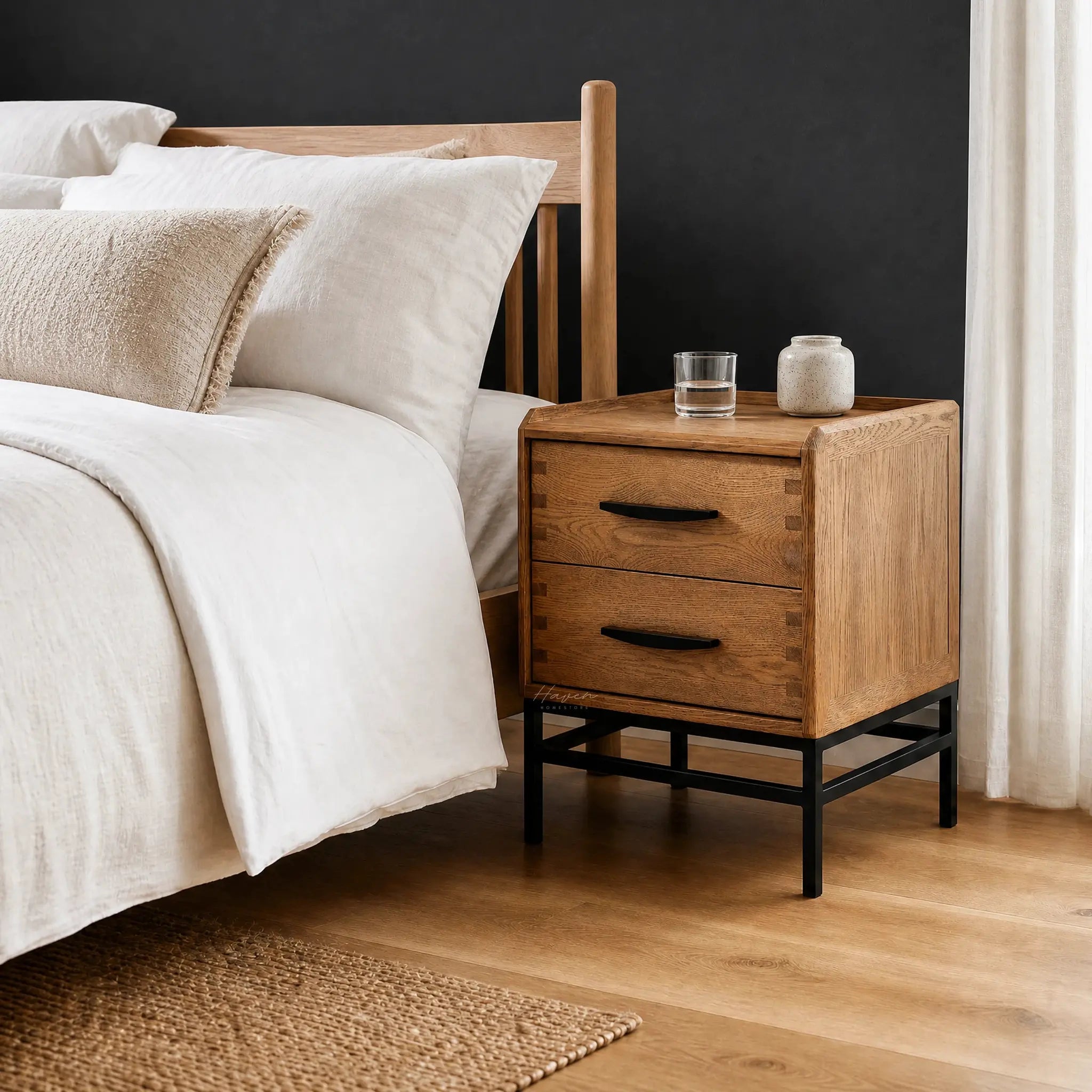 Carlton 2 Drawer Bedside table in natural oak grain with black handles and slim metal base.