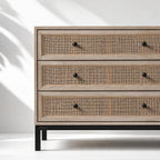 Cadrona 3 Drawer Commode with woven rattan fronts, timber frame, and slim black iron base.
