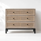 Cadrona 3 Drawer Commode with woven rattan fronts, timber frame, and slim black iron base.