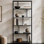 Lorenzo Metal Bookshelf in black steel, showcasing books, ceramics, and greenery.
