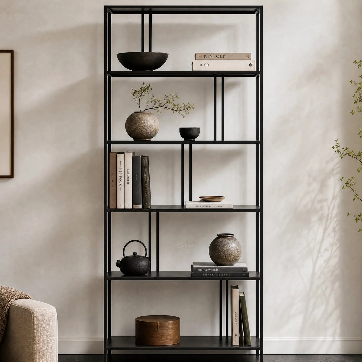 Lorenzo Metal Bookshelf in black steel, showcasing books, ceramics, and greenery.