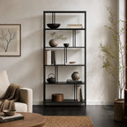 Lorenzo Metal Bookshelf in black powder-coated steel with slim frame, displaying books, bowls, and plants.