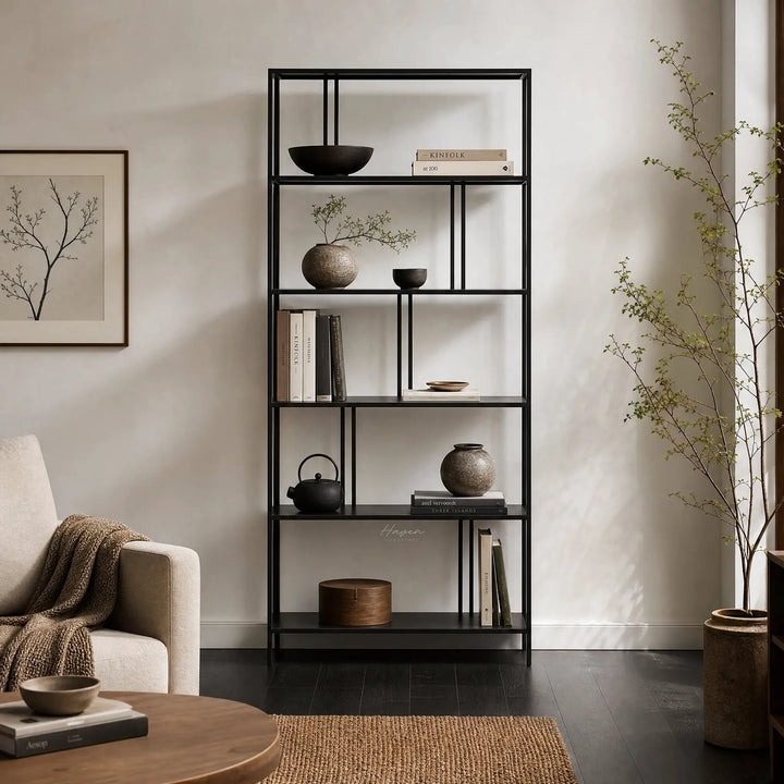 Lorenzo Metal Bookshelf in black powder-coated steel with slim frame, displaying books, bowls, and plants.