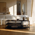 Lorenzo Metal Coffee Table with powder-coated black steel, slim frame and open shelves in a modern living room.