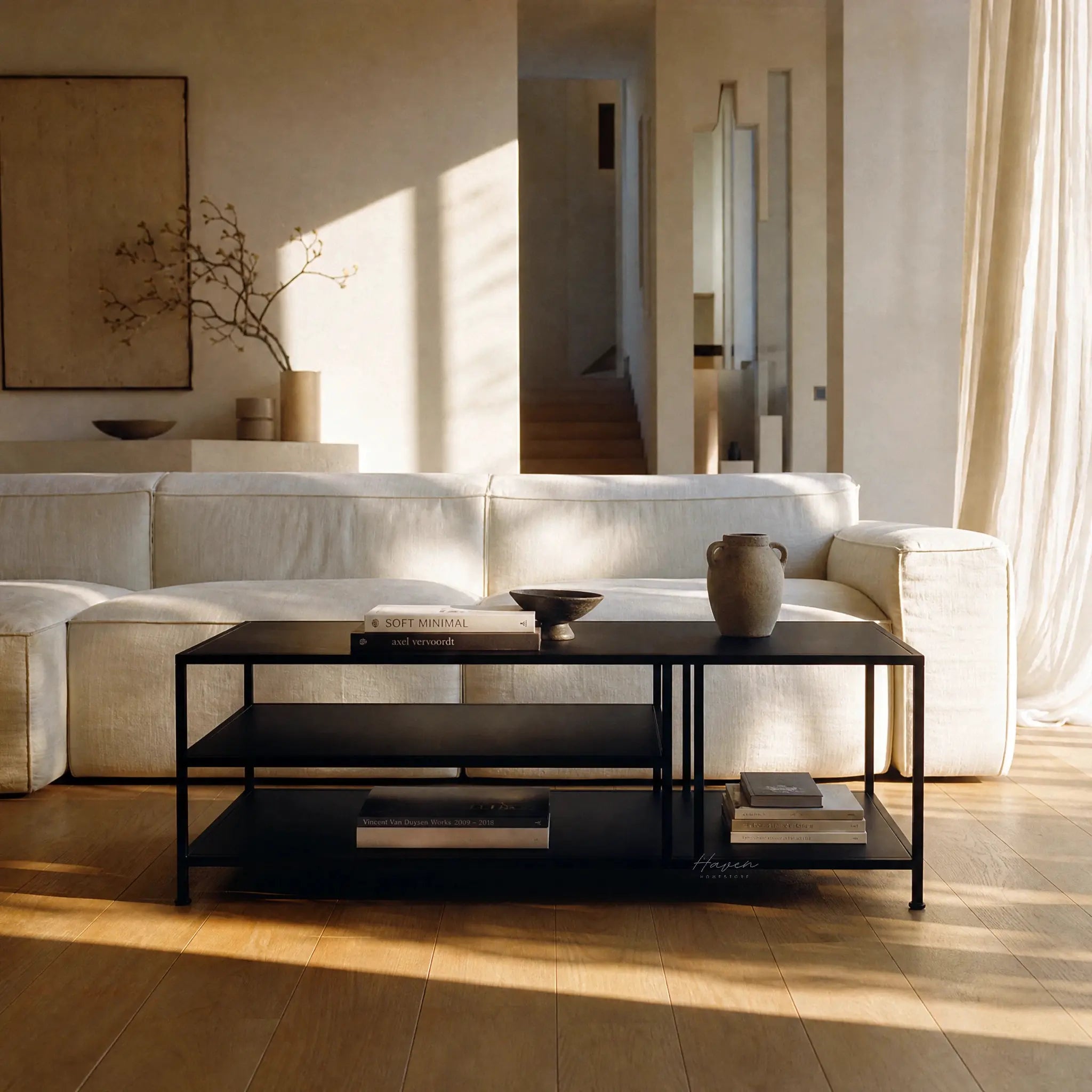 Lorenzo Metal Coffee Table with powder-coated black steel, slim frame and open shelves in a modern living room.