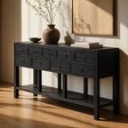 Blackwood Sideboard in sandblasted ebony oak with grain and ring-pull drawers, topped by a vase and books.