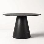Charlie Dining Table with a rounded top and sculptural pedestal base in black oak veneer.