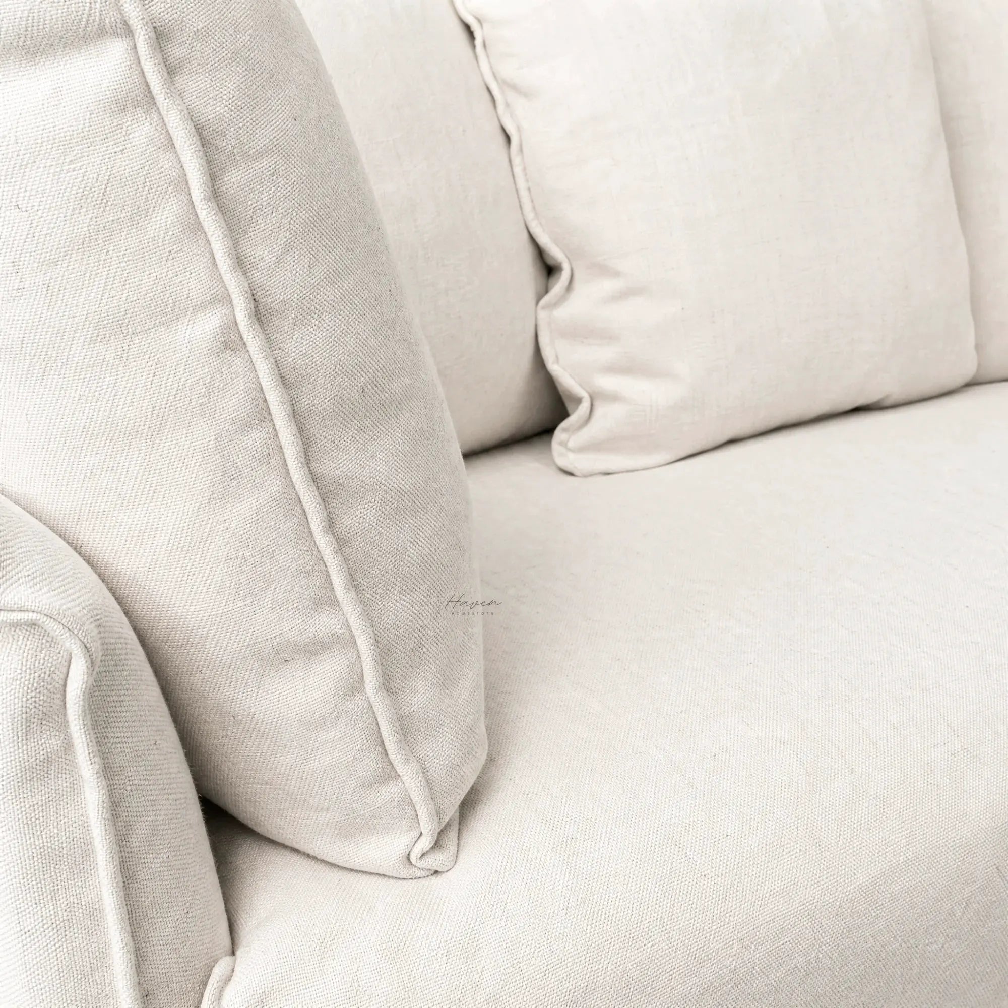 Cove Slipcover Sofa 2-Seat in soft linen-cotton beige with feather and foam cushions.