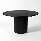 Sora Dining Table - Black with a round top and fluted pedestal base, fir wood and timber veneer.