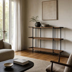 Hakari Shelves - Natural: oak shelves with slim black iron frame in a sunlit living room.