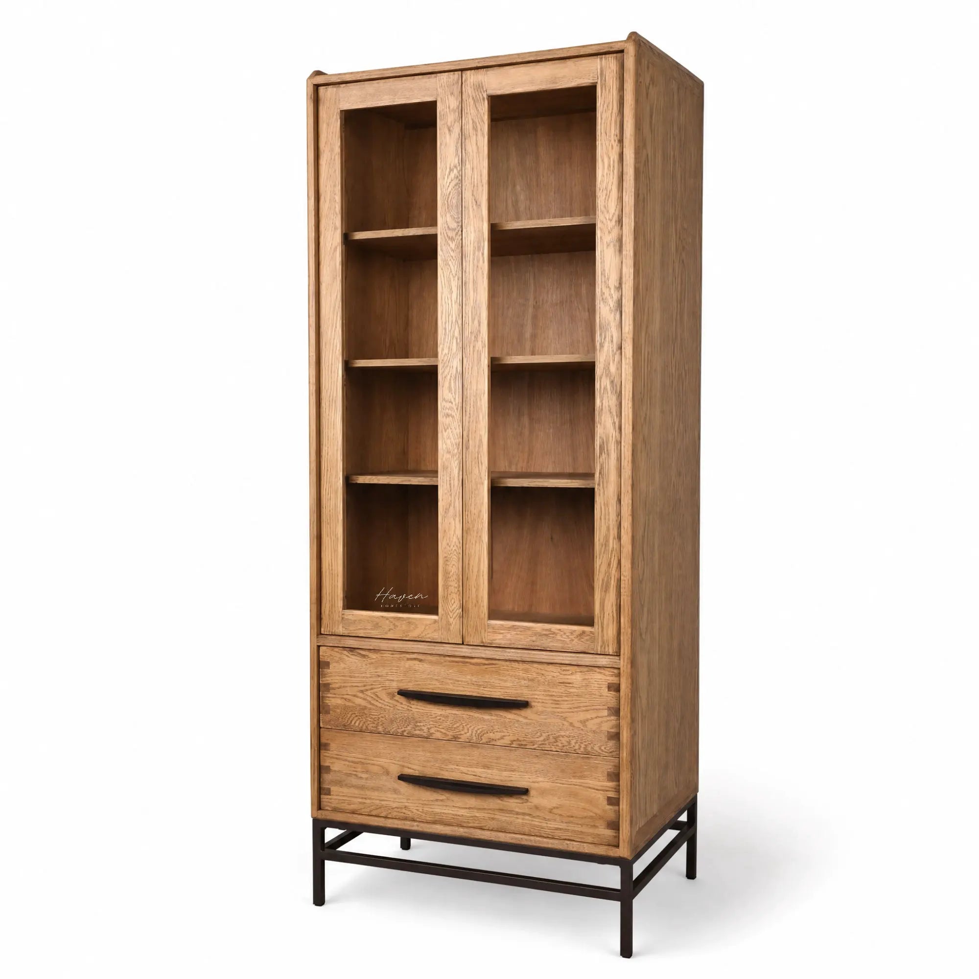 Halden Display Cupboard in solid oak with glass-front doors, open shelving, and a lower drawer on a black metal base.