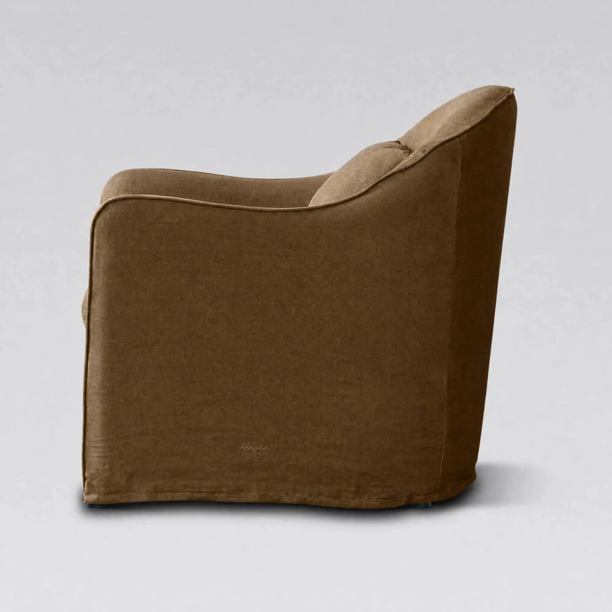 Back view of a Nella slipcover chair upholstered in warm Mocha linen, featuring a relaxed removable cover and softly curved silhouette.