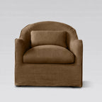 Nella slipcover armchair in warm Mocha linen with a curved back, plush seat, and matching lumbar pillow.
