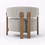 Rear view of the Seki Chair in Pumice, featuring a curved upholstered back and solid ash timber frame.