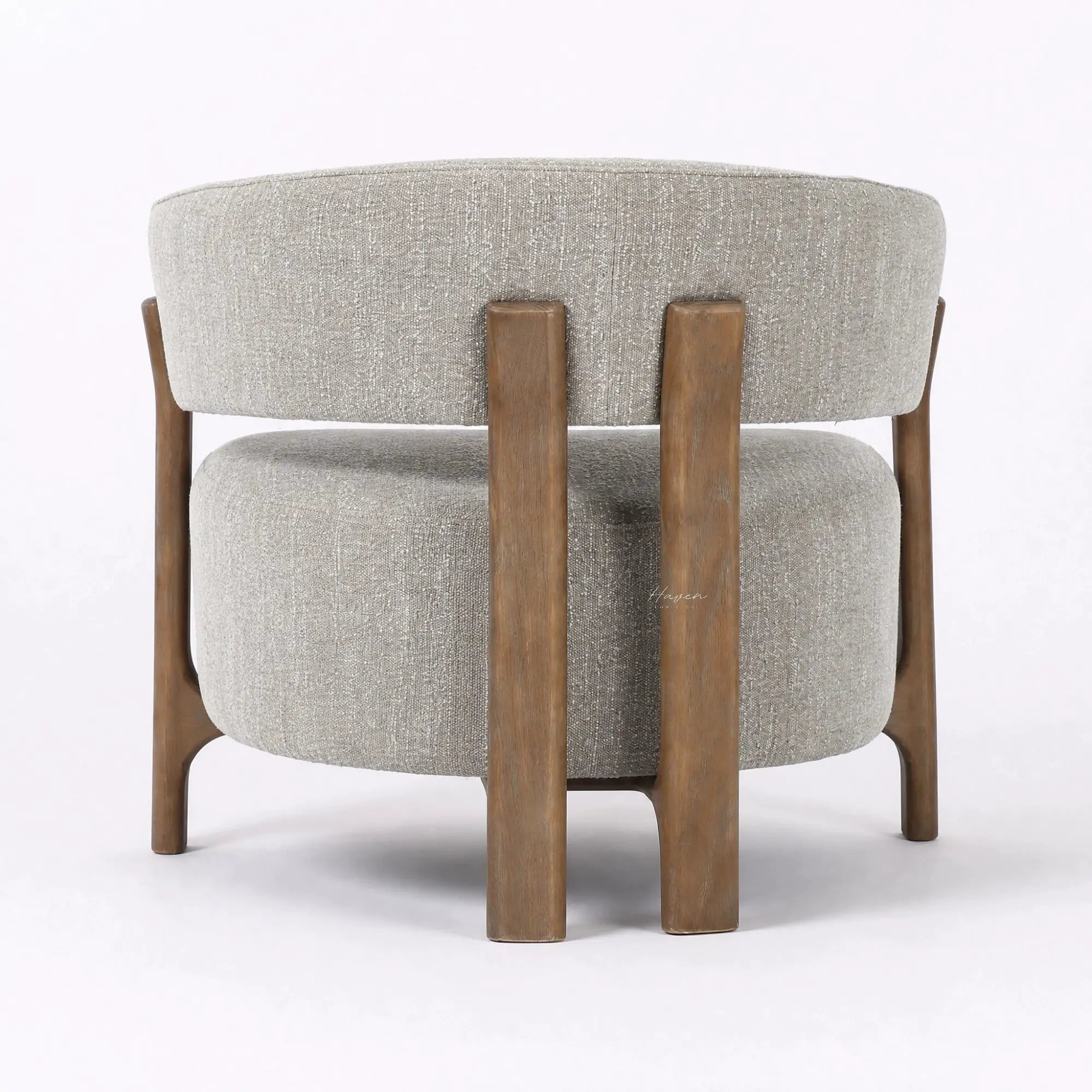 Rear view of the Seki Chair in Pumice, featuring a curved upholstered back and solid ash timber frame.